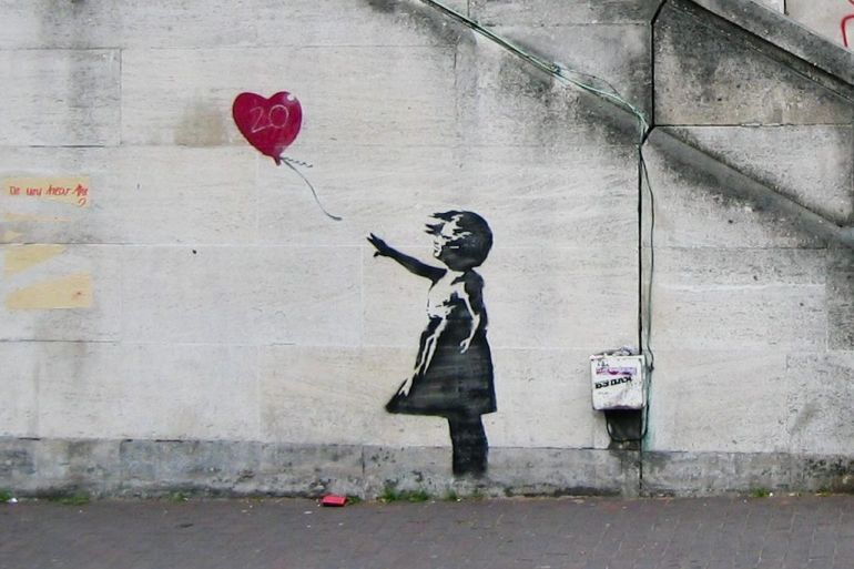 Banksy_Girl_and_Heart_Balloon_2840632113-e1726812622108.jpg